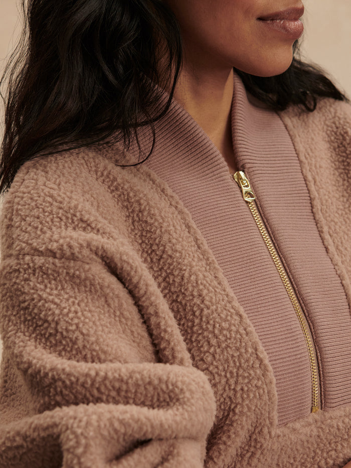 Ginger Snap|Model wearing Varley Mumford Half Zip Fleece in Ginger Snap, a warm tan fleece with a standing collar and half-zip placket.