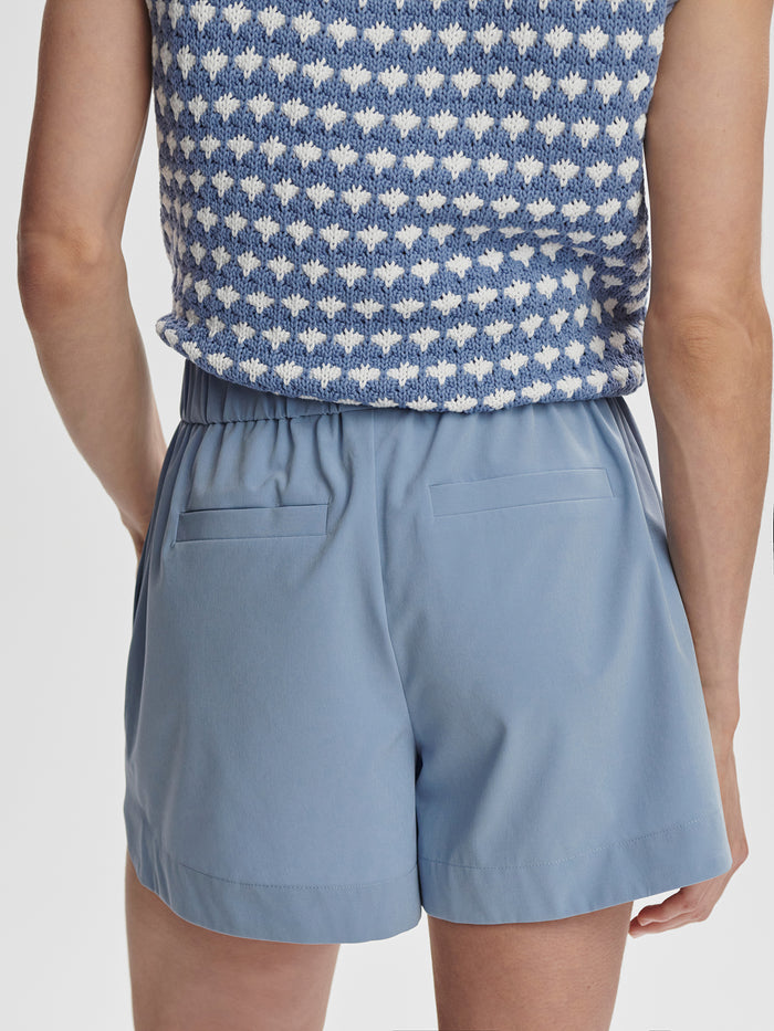 Rain Blue|Front-facing product image of the Varley Nila mid-rise short in Rain Blue, lightweight athletic shorts with a secure waistband and clean silhouette.