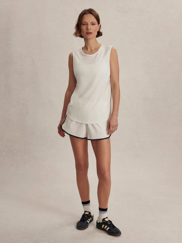 White|Front-facing Varley Nolan Seamless Longline Tank in White, a seamless sleeveless athletic tank with extended length and lightweight fabric.