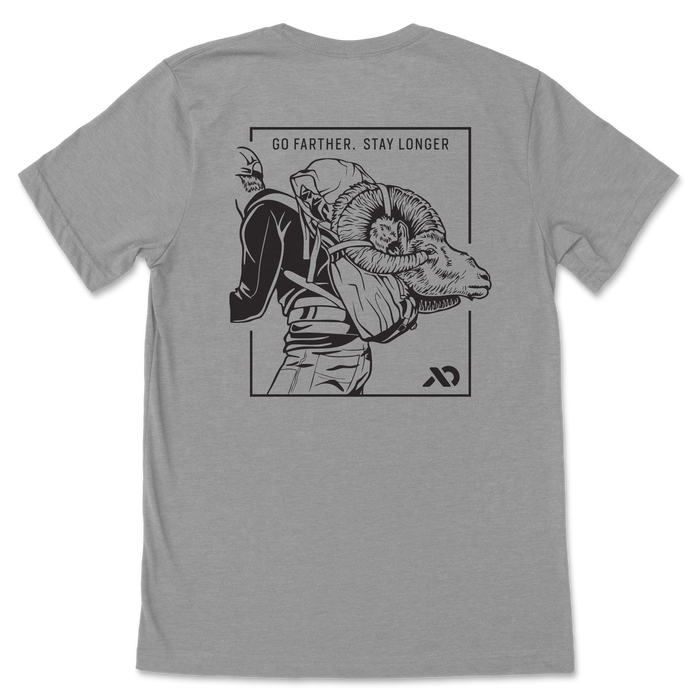 Grey t-shirt with a black graphic on the back: a framed illustration of a person carrying a bighorn ram, topped by the text 'GO FARTHER. STAY LONGER'.