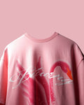 Pink T-Shirt with a graphic design on a pink background