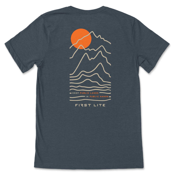 Dark heather gray t-shirt with a back graphic of an orange sun behind tan outline mountains, with the text "KEEP PUBLIC LANDS IN PUBLIC HANDS" and "FIRST LITE" below.