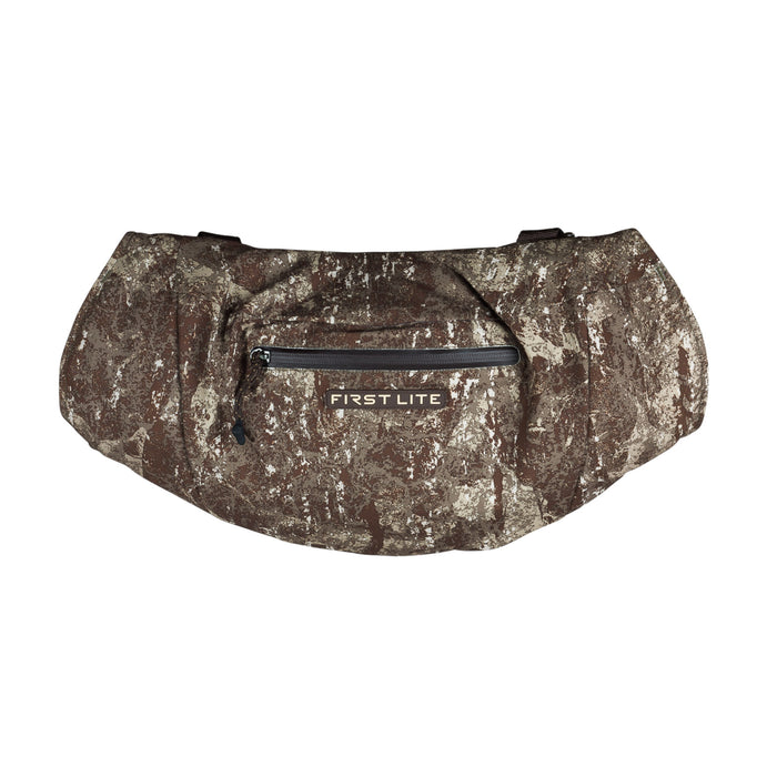 Multi-tone camouflage hand muff with a front zippered pocket and First Lite logo.