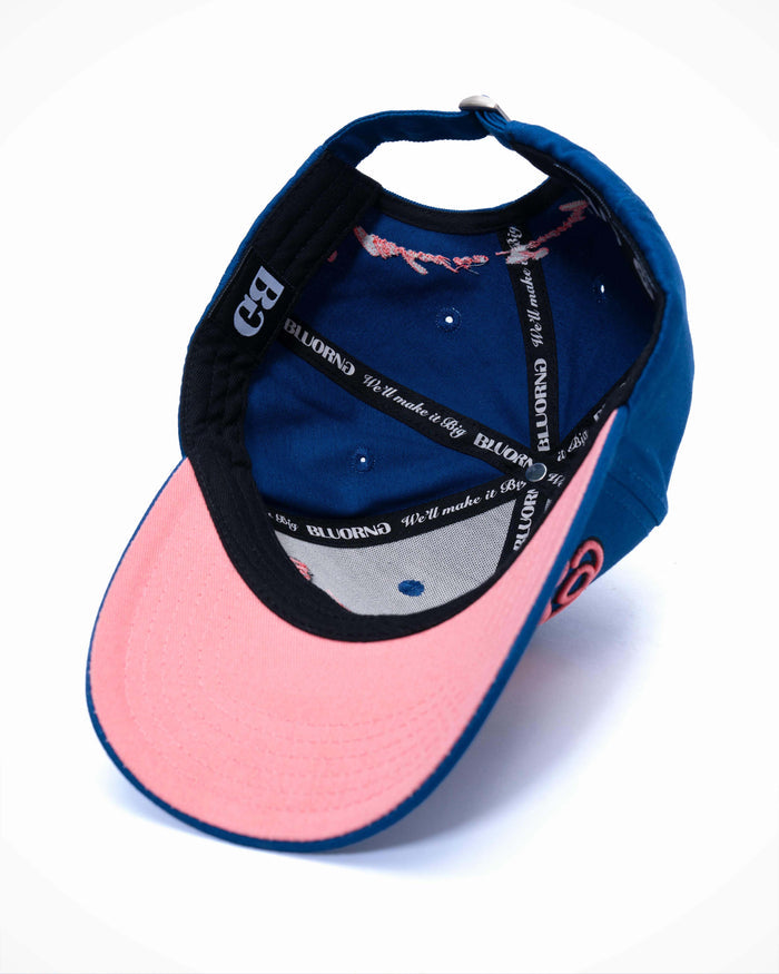Blue and pink cap with brand logo on a white background