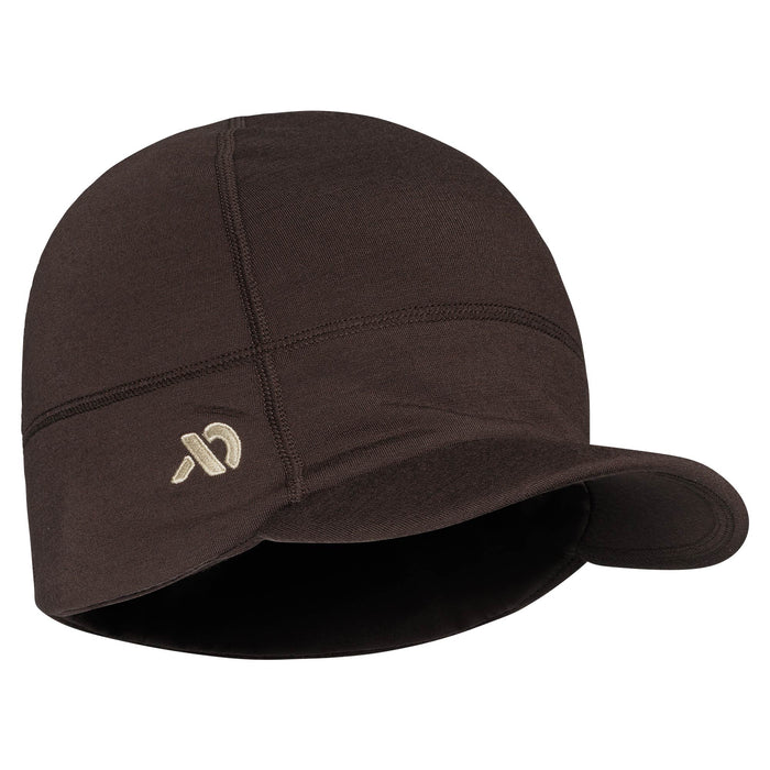 Dark brown skull cap with a short brim, extended sides, visible flatlock seams, and a tan embroidered logo.