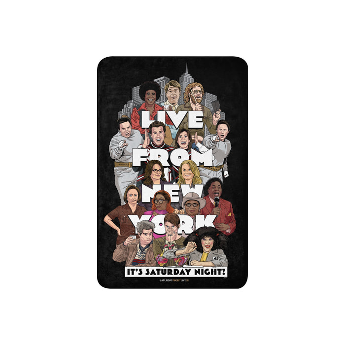 Saturday Night Live sherpa blanket draped over a living room sofa, displaying the full front Live From New York design
