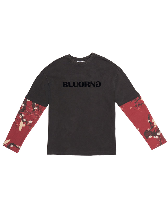 A long-sleeve t-shirt in dark charcoal gray with 'BLUORNG' printed in black across the chest, featuring red floral patterned sleeves.