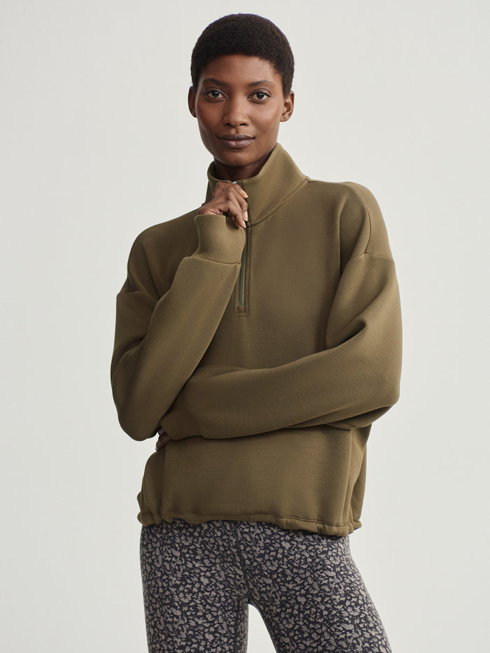 Dark Olive|Sian Cropped Half-Zip Sweat in Dark Olive, relaxed-fit midlayer with cropped silhouette, internal hem drawcord, thumbholes and front zip pockets.