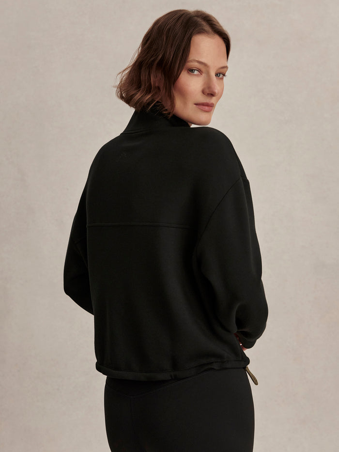 Black|SIAN Cropped Half-Zip Midlayer in Black, front view showing a stand collar and subtle zip on a lightweight knit midlayer.