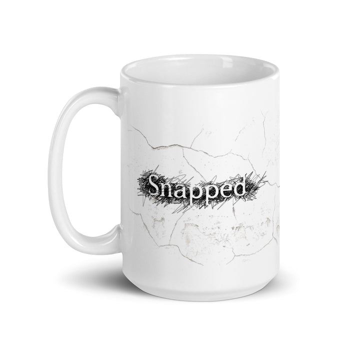 Front view of the white ceramic mug featuring the Snapped logo