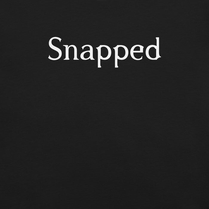 Close-up of Snapped logo graphic on t-shirt