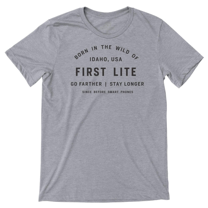 Gray t-shirt featuring black text graphic "Born in the Wild of Idaho, USA First Lite Go Farther | Stay Longer Since Before Smart Phones".