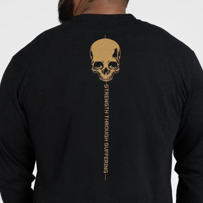 Black long-sleeve shirt with a gold skull design and text on the back, worn by a person.