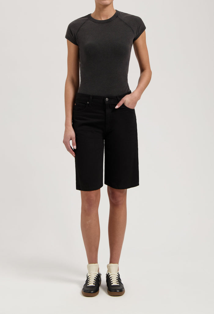 Casual black denim knee-length shorts paired with a fitted dark gray t-shirt, showcasing a relaxed summer style.