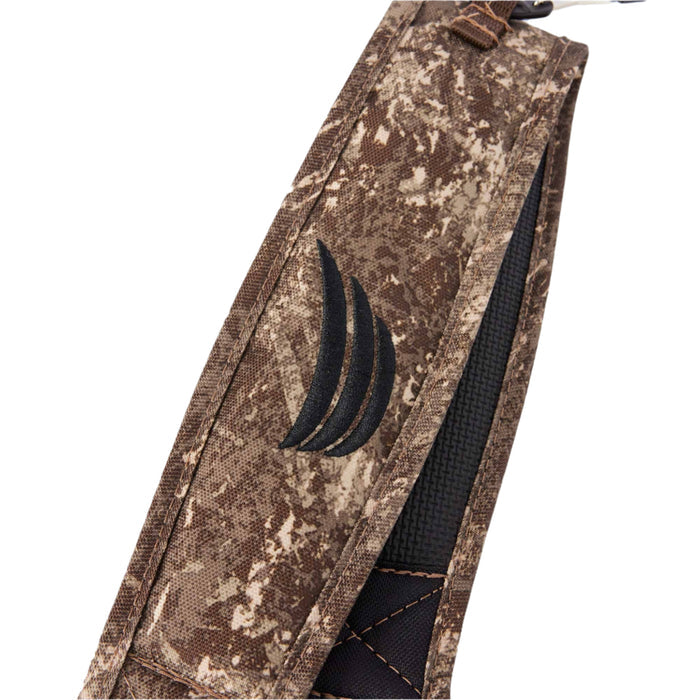 Brown camouflage rifle sling featuring a black textured grip pad and an embroidered black logo.