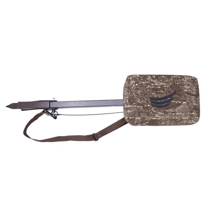 camouflage hunting seat with a dark pole, ground spike, brown shoulder strap, and curved black logo on the cushion.