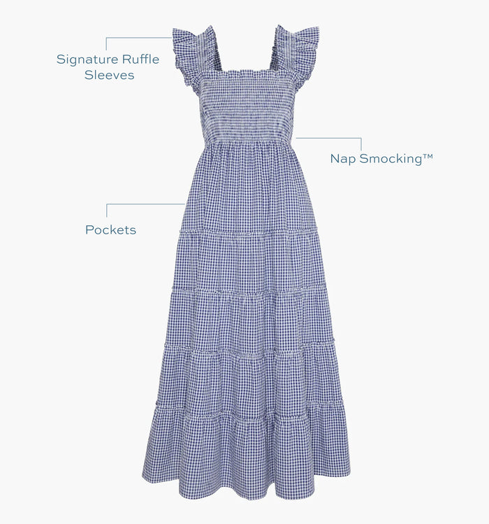 Image of a Nap Dress with text highlighting it's Signature ruffle sleeves, Nap Smocking™,  and Pockets color: Navy Stripe