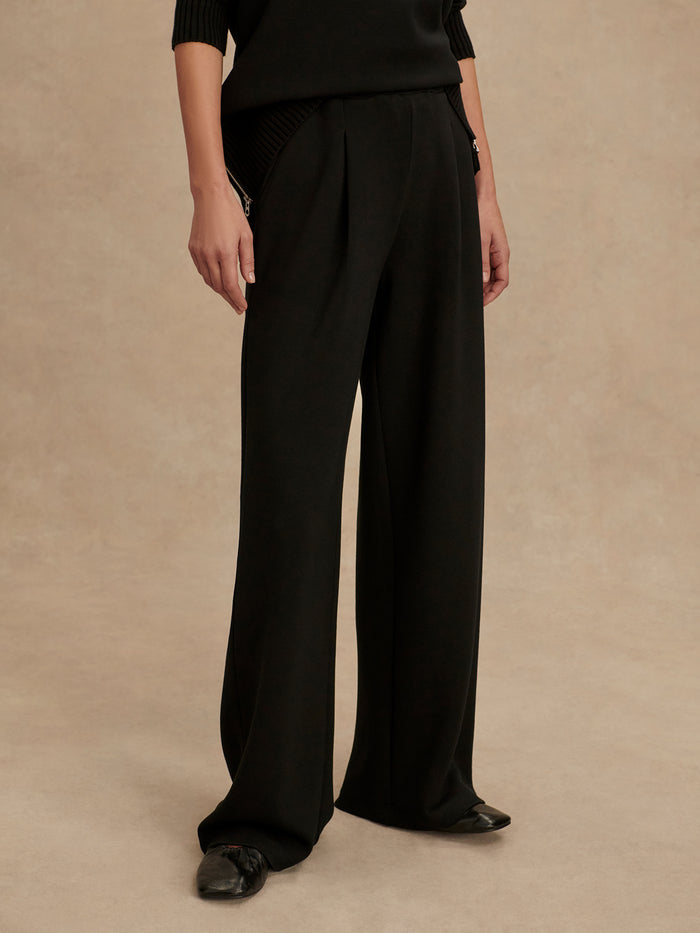 Black|Front view of The Extra Wide Leg Pant 29.5 in black, with a high waist, front pleats, fully elasticated waistband and pockets, in DoubleSoft fabric.