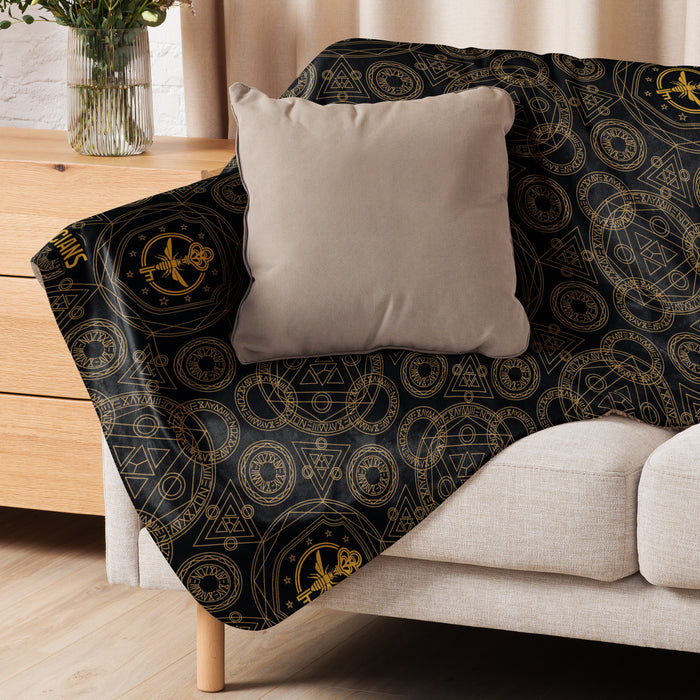 Lifestyle view of The Magicians Brakebills University blanket on a couch
