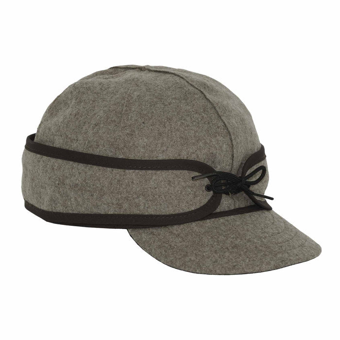 Olive grey felted wool cap with ear flaps, a brim, dark brown trim, and a black cord tied on the side.