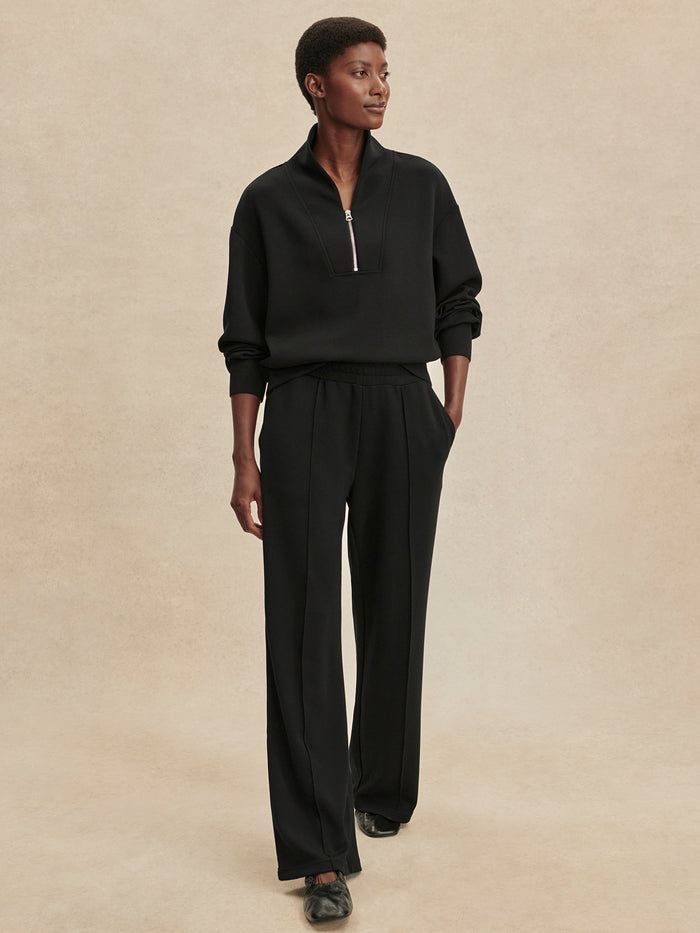 Black|The Wide Leg Pant 32 in Black by Varley, DoubleSoft® fabric, high-rise waist, elasticated drawcord, wide-leg silhouette, pink tuck detailing.