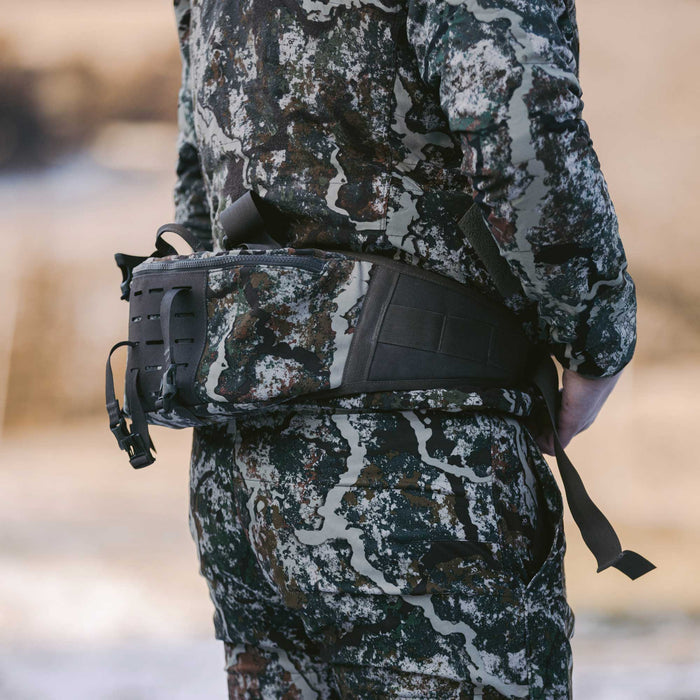 Camouflage lumbar pack featuring a dark padded back panel and side MOLLE webbing.