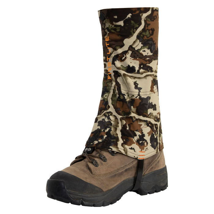 First Lite Fusion camouflage gaiter with orange branding, shown worn over a brown hiking boot.