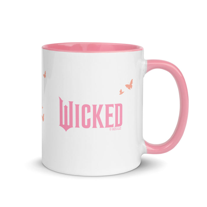 Front view of the Wicked two-tone pink coffee mug showcasing the whimsical text design