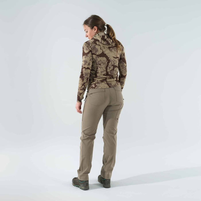Woman from behind wearing a brown camouflage long-sleeve hooded top and khaki utility pants.