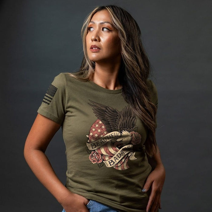 Woman wearing a green t-shirt with a graphic design on a dark background