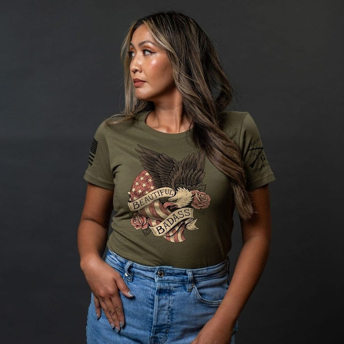 Woman wearing a green t-shirt with a graphic design on a dark background