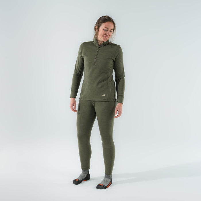 A woman models an olive green thermal base layer set with a quarter-zip long-sleeve top and matching leggings.