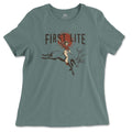 Muted teal t-shirt featuring "FIRST LITE" text above a graphic of a cowgirl riding a leaping elk against a red sun.
