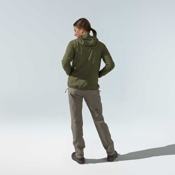 Back view of a woman wearing an olive green hooded jacket with subtle quilting and Walnut cargo pants.